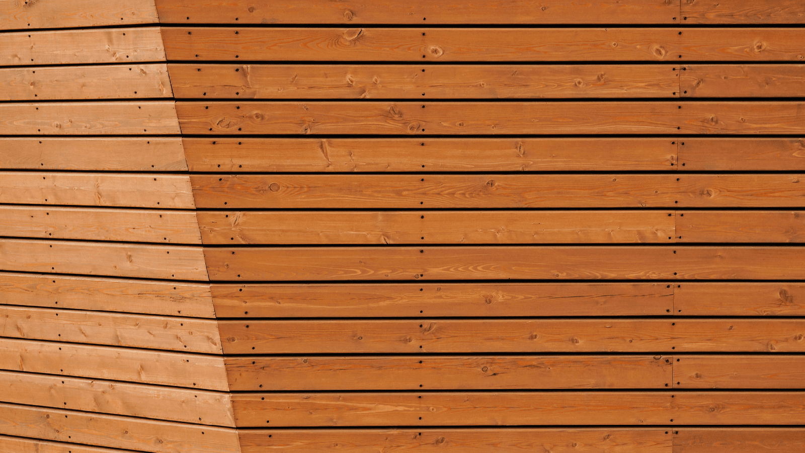 Freshly stained cedar fence with rich, even color